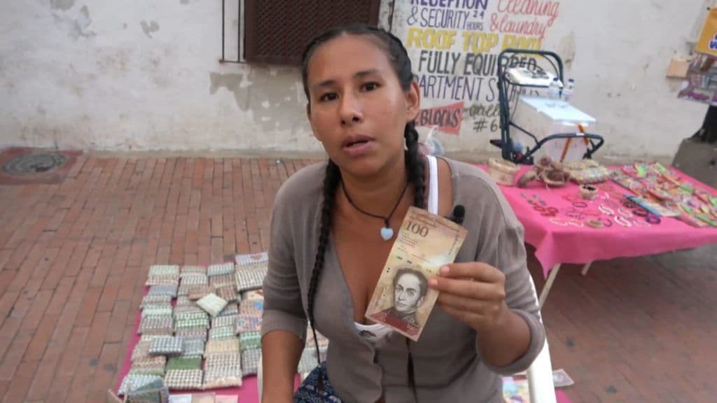 Refugee selling craft made of worthless cash